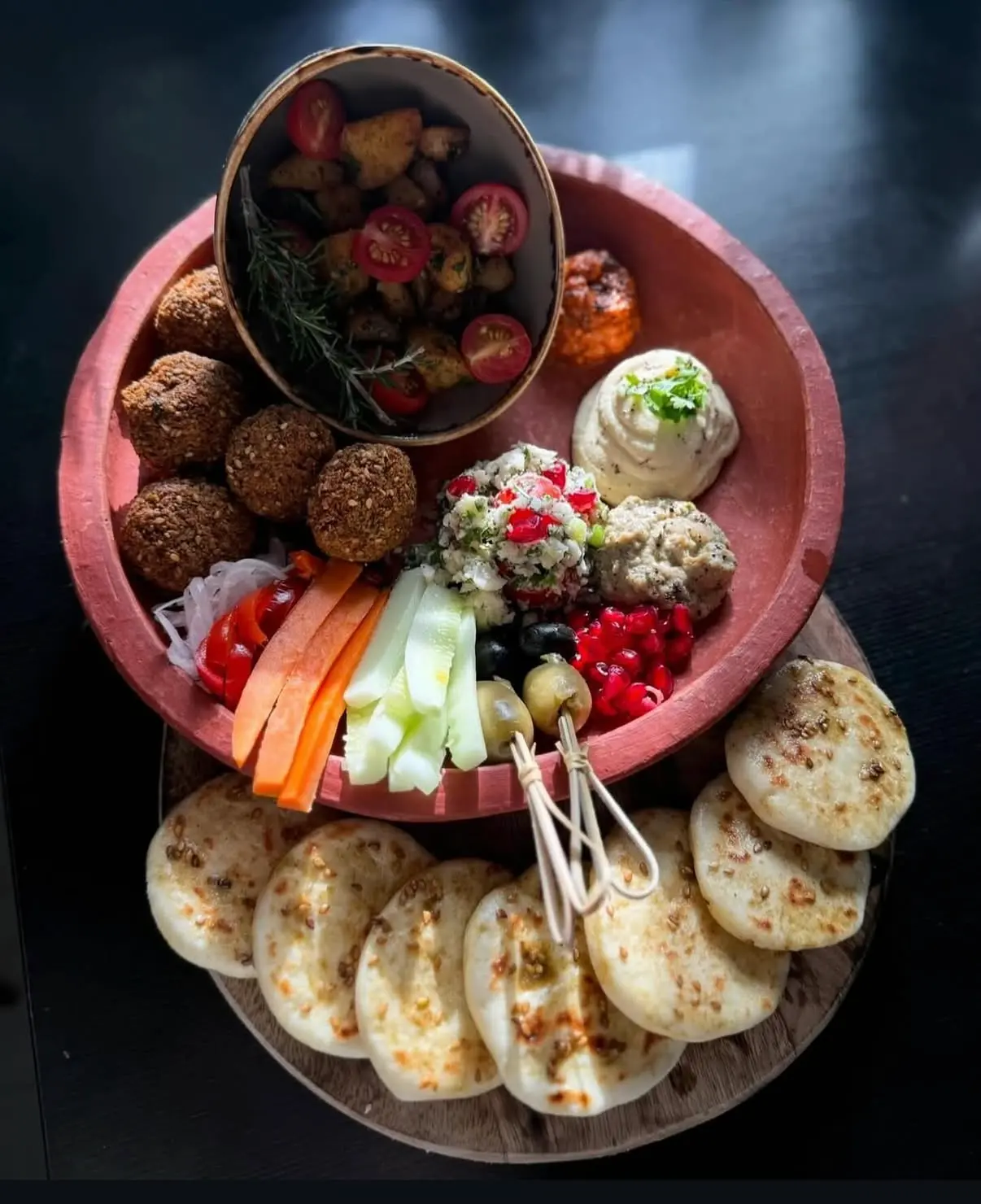 A vegan tapas platter of falafel, dips, fresh vegetables and flatbread by chef Priti