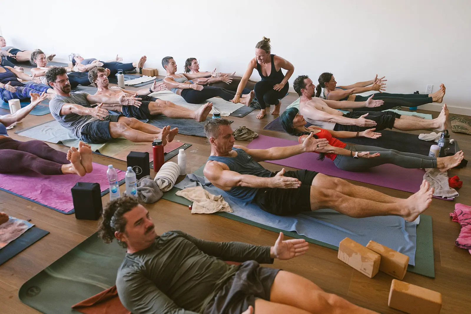 Group of yoga students in boat pose